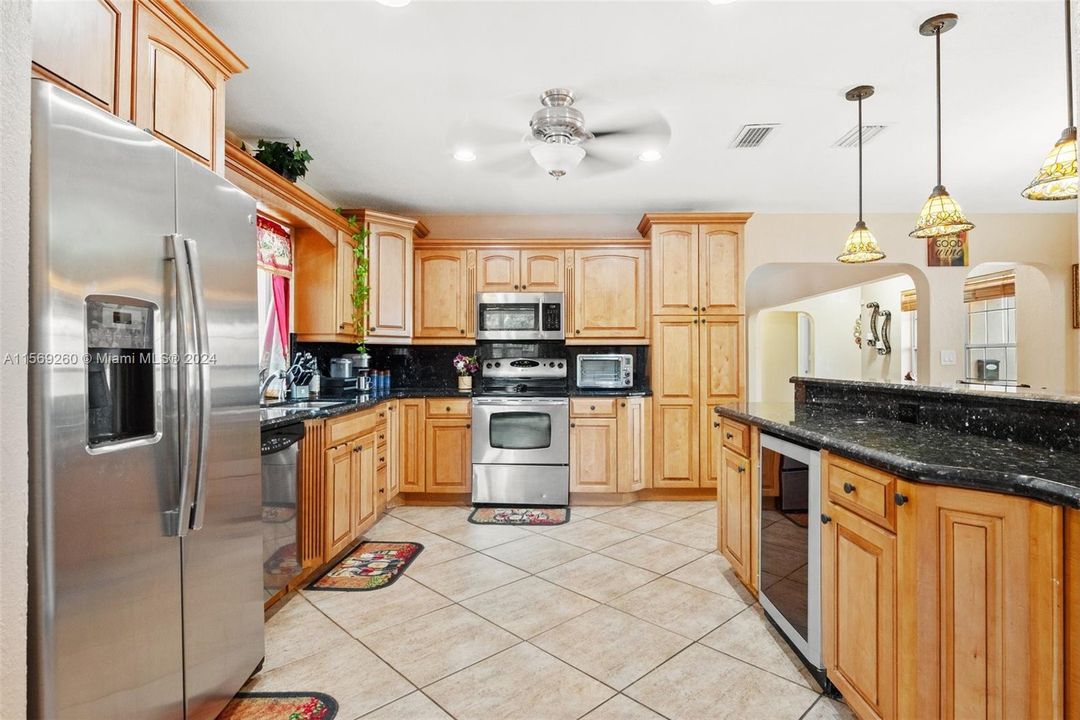 Large kitchen wood cabinets & granite