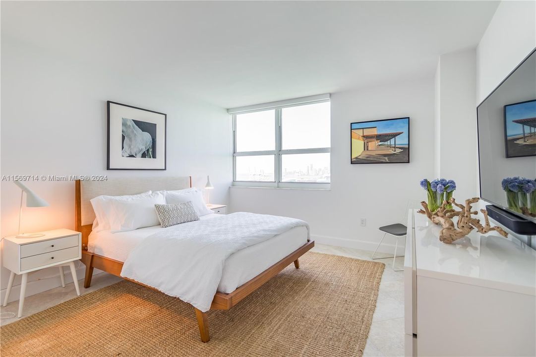 Spacious bedroom with direct bay views