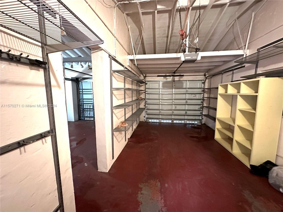 Inside of 2 Car Garage with ample storage and a second Refrigerator.