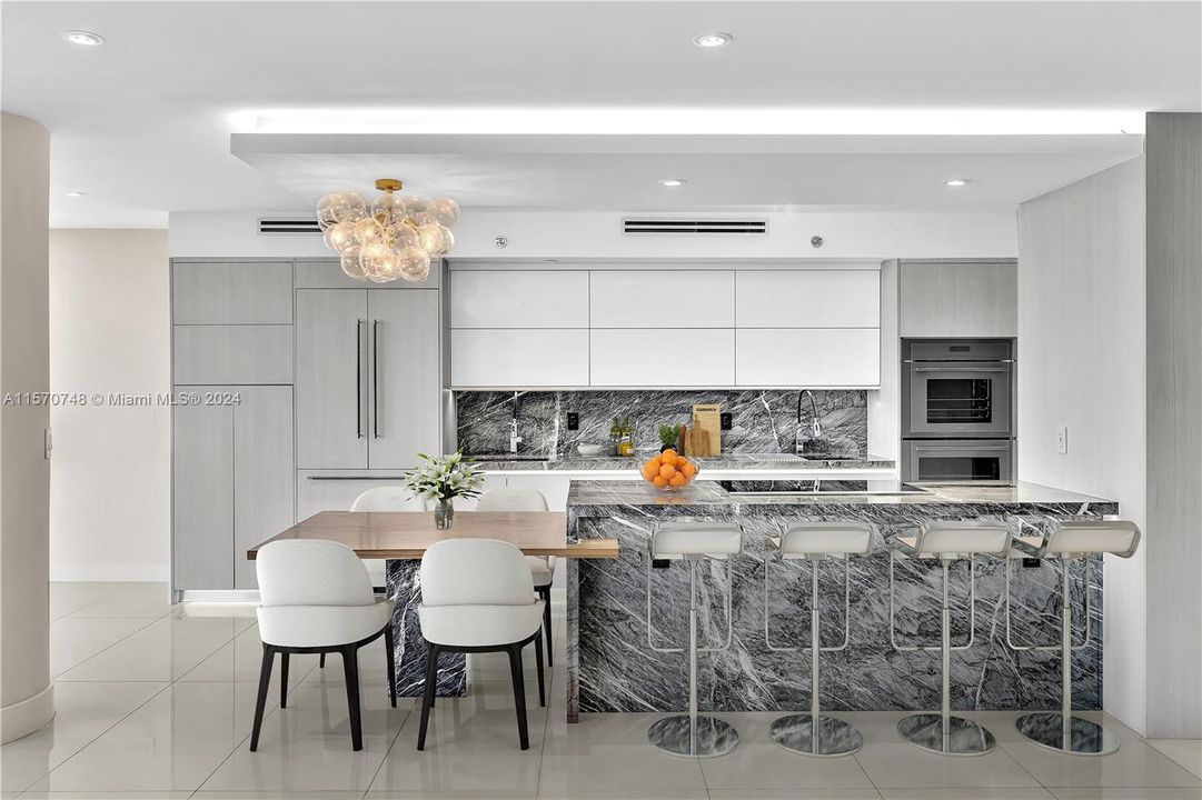 ARCHITECTURALLY REDESIGNED UNIT WITH THE FINEST AND MOST BEAUTIFUL FINISHES! THE USE OF NATURAL WOOD AND STONE IS DONE EXQUISITELY BY A DESIGNER, VERY HIGHEND APPLIANCES AND TWO SINKS. EXTRA SEATING AROUND THE KITCHEN IS PERFECT FOR INFORMAL GATHERINGS FORFAMILY AND GUESTS!