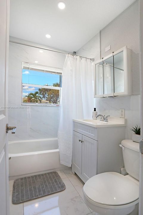 Totally Remodeled Marble Guest Bathroom with Impact Window