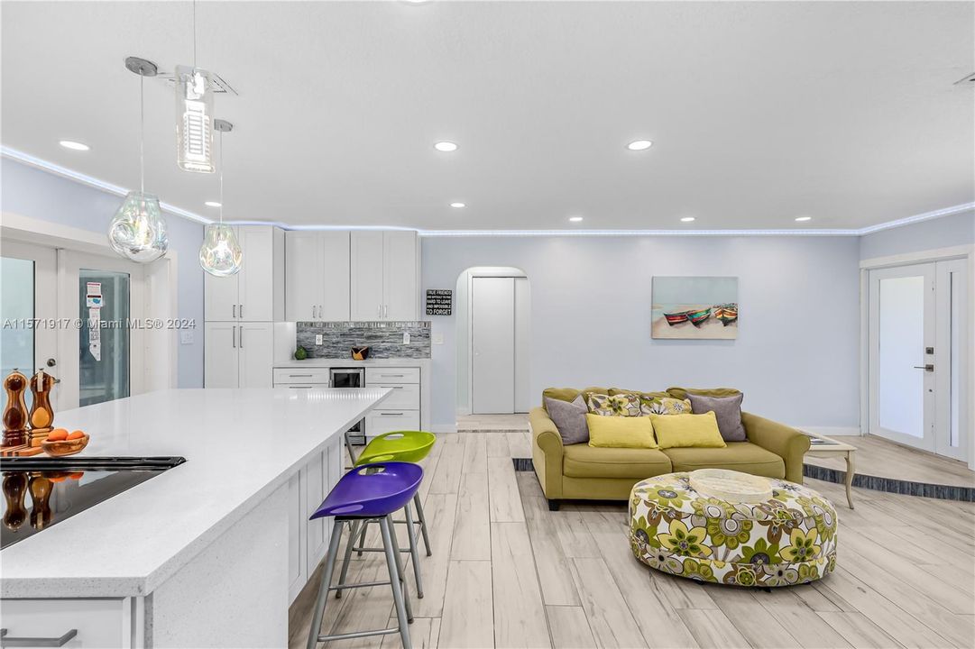 Fully updated Kitchen featuring Soft Close White Cabinetry, Waterfall Quartz Countertops, Stainless Appliances, Tile Backsplash, Recessed And Modern Lighting and so much more!