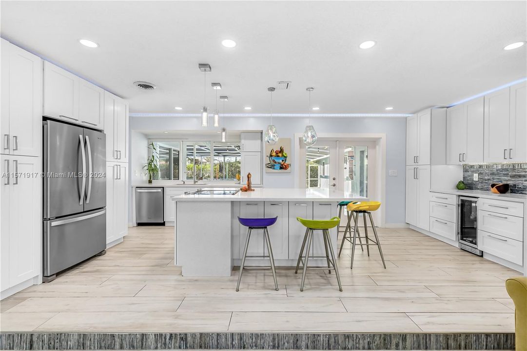 Fully updated Kitchen featuring Soft Close White Cabinetry, Waterfall Quartz Countertops, Stainless Appliances, Tile Backsplash, Recessed And Modern Lighting and so much more!