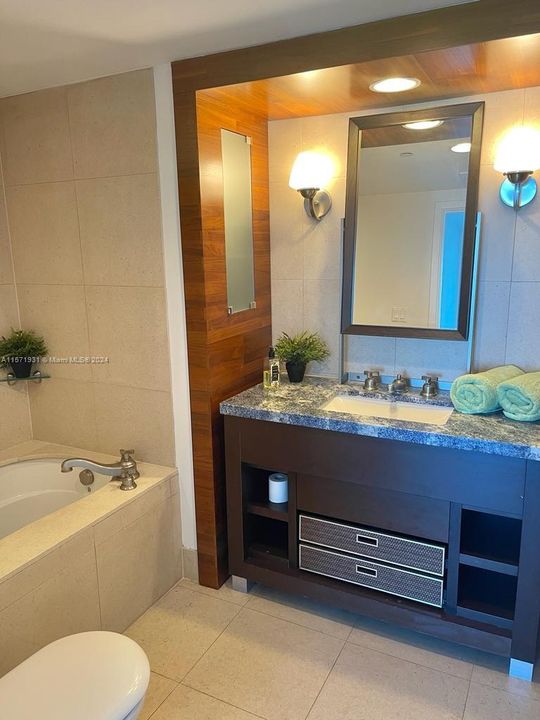 Bathroom with jetted soaking tub and a separate shower area
