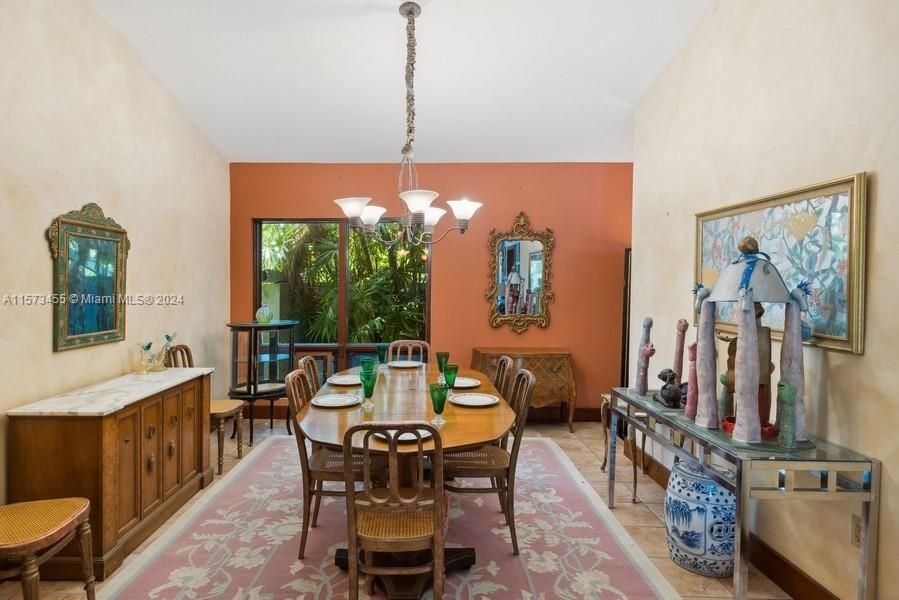 Formal dining area with vaulted ceilings and more views to the gardens