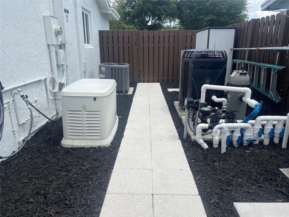 SideSide yard with pool equipment, generator and A/C