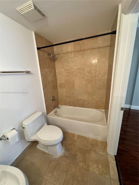 En suite bathroom Bath tube and shower