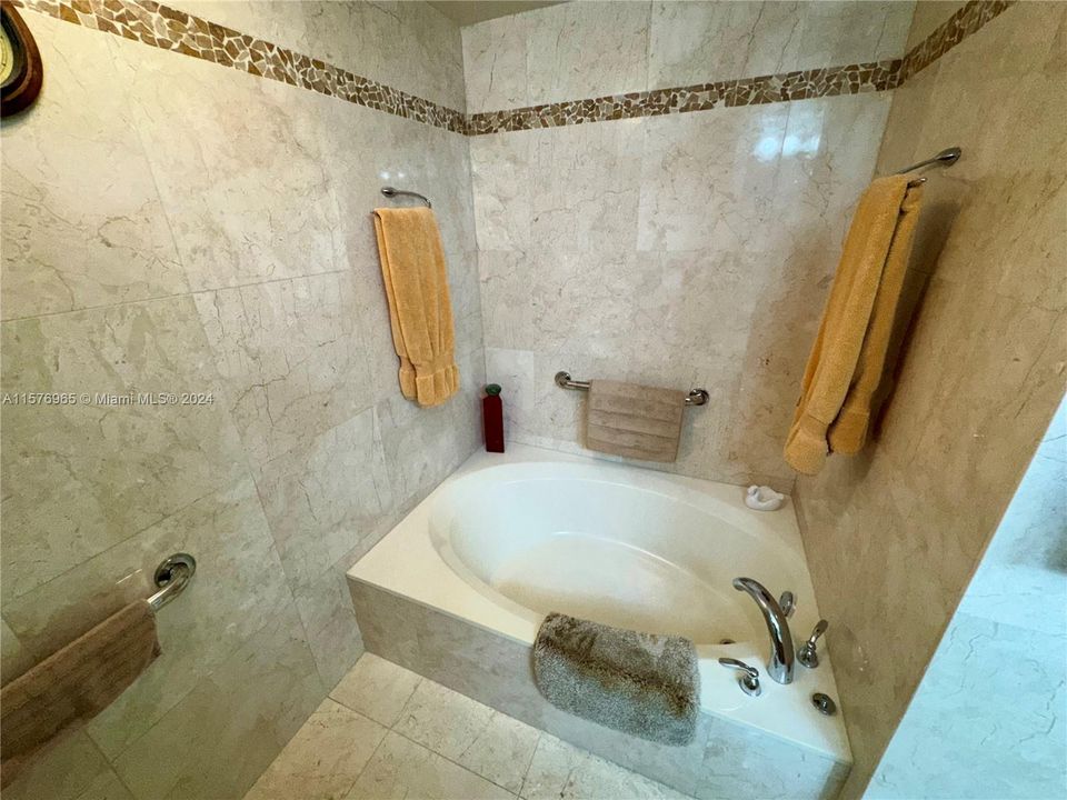All Hand Built Custom Cherry and Quartz Granite Master BathGold in-lay Vessel Sinks W/ Europian HansGrohe fixtires throughoutW/ Seamless Glass Shower Stall and Large Roman Jacuzzi Spa18" Marble with Custom tumbled pepple stone in-lay