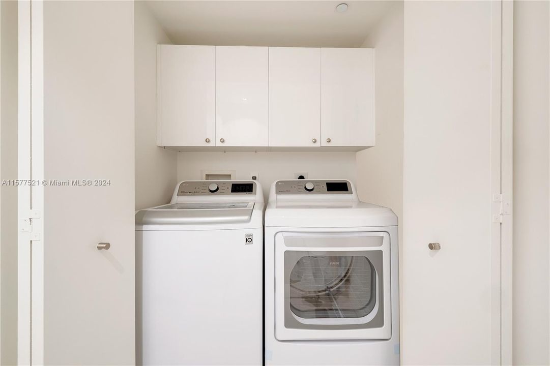 Full-size washer dryer in powder room closet