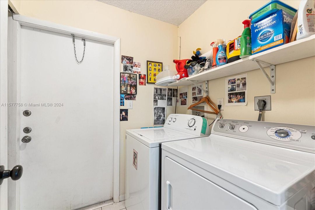 Laundry room with door leading into the carport