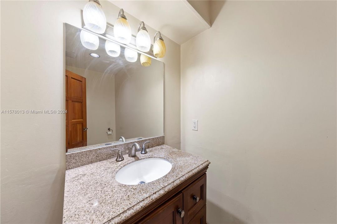 FULL SIZE BATHROOM W/ DOUBL SINKS DOWNSTAIRS AND OPENS TO BAC PATIO