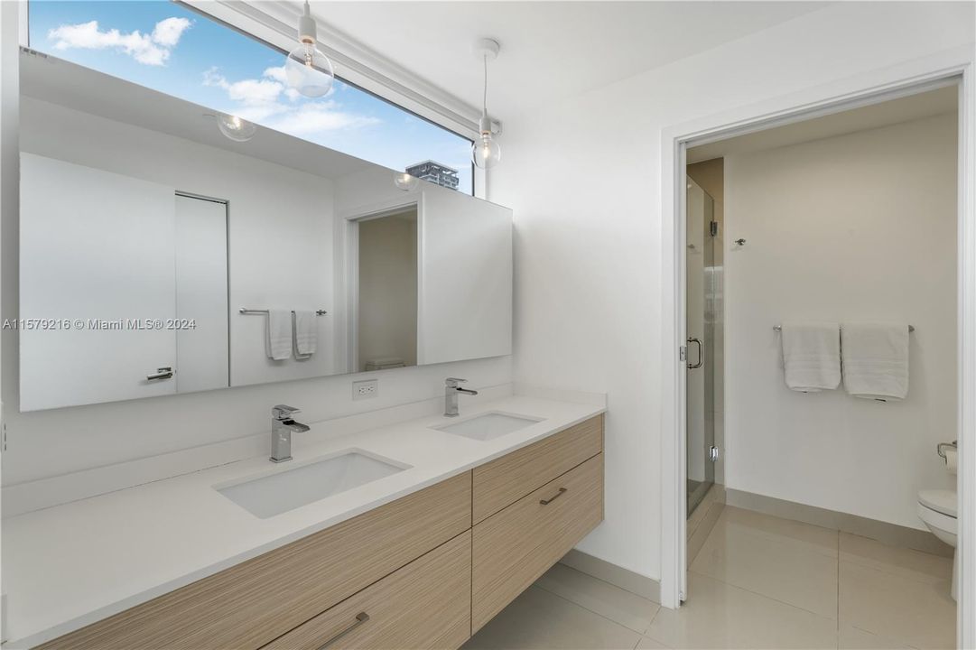Primary bathroom with dual vanity and shower