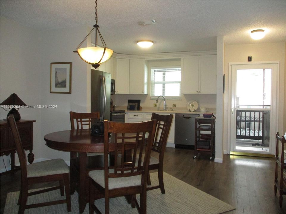 VIEW FROM LIVING/DINING TO ENTRANCE WITH SCREENED GLASS DOOR