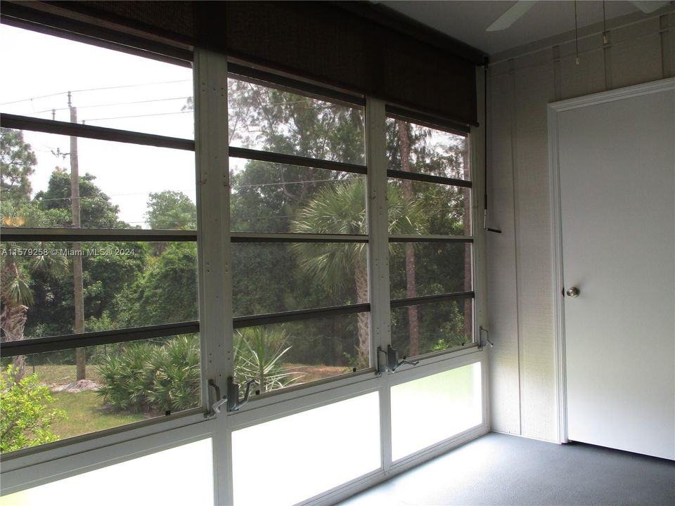 GREEN GARDEN VIEW WITH PULL DOWN AWNING ON WINDOWS & ACCORDION SHUTTERS ON BOTH SLIDING DOORS FROM LIVING & MASTER BEDROOM ONTO THE PATIO