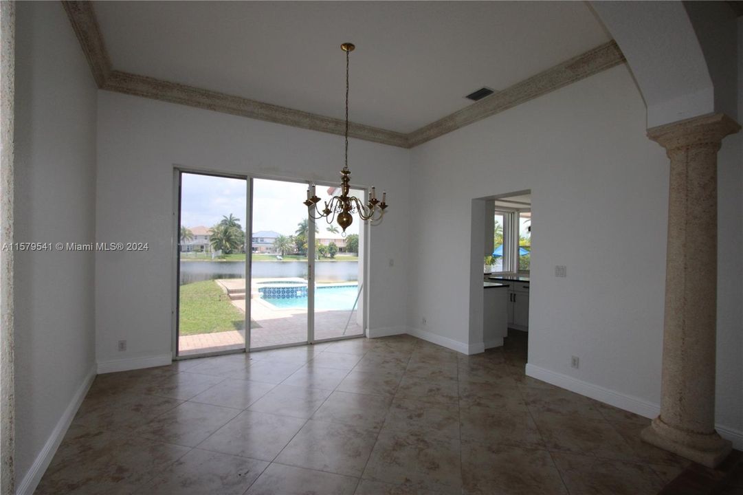 FORMAL DINING ROOM W/ A VIEW OF POOL/LAKE