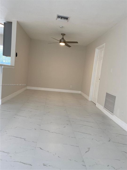 To the right side of the kitchen , open area ideal for family room ,tile throught.