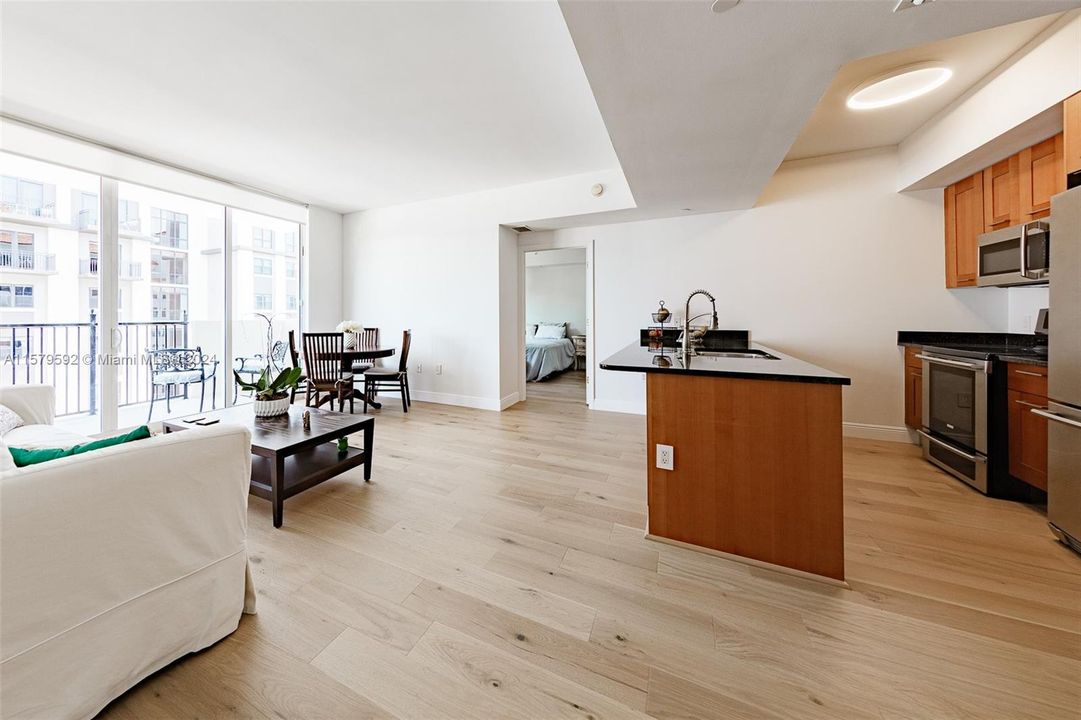 Living room, dining space, patio door, kitchen note Engineered Wood Floors