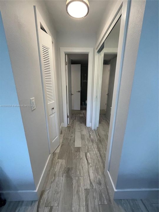 Hallway w closets into bathroom