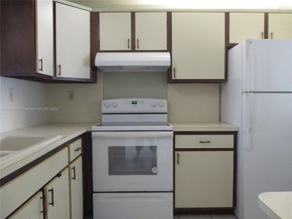 KITCHEN AREA WITH WHITE APPLIANCES