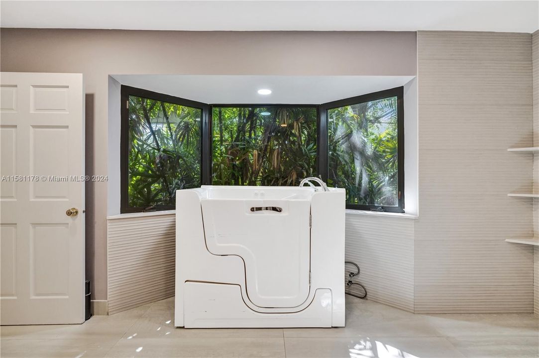 At the center of the space, the modified tub stands as a focal point of relaxation and indulgence, its streamlined silhouette and innovative features offering a blend of comfort and style. From its sculpted curves to its integrated jets, every detail is meticulously crafted to enhance the bathing experience