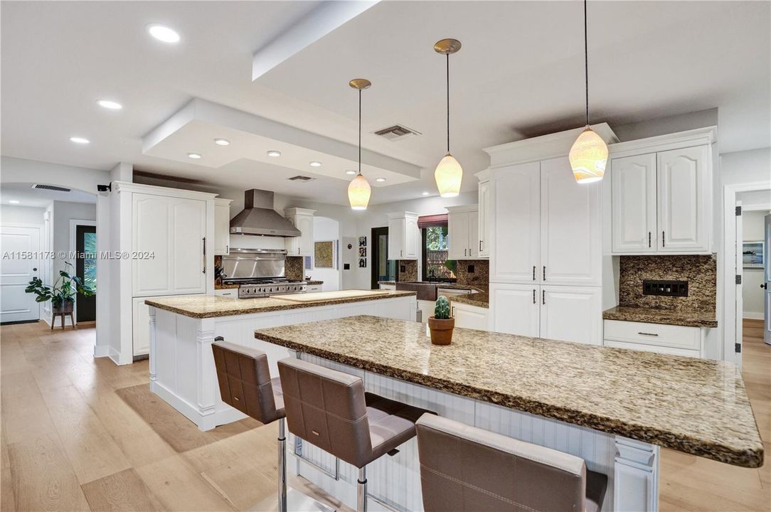 Expansive island, crowned with the same elegant granite, offers both a gathering place for casual conversation and a practical workspace for culinary endevours. Security camera system and surround sound.