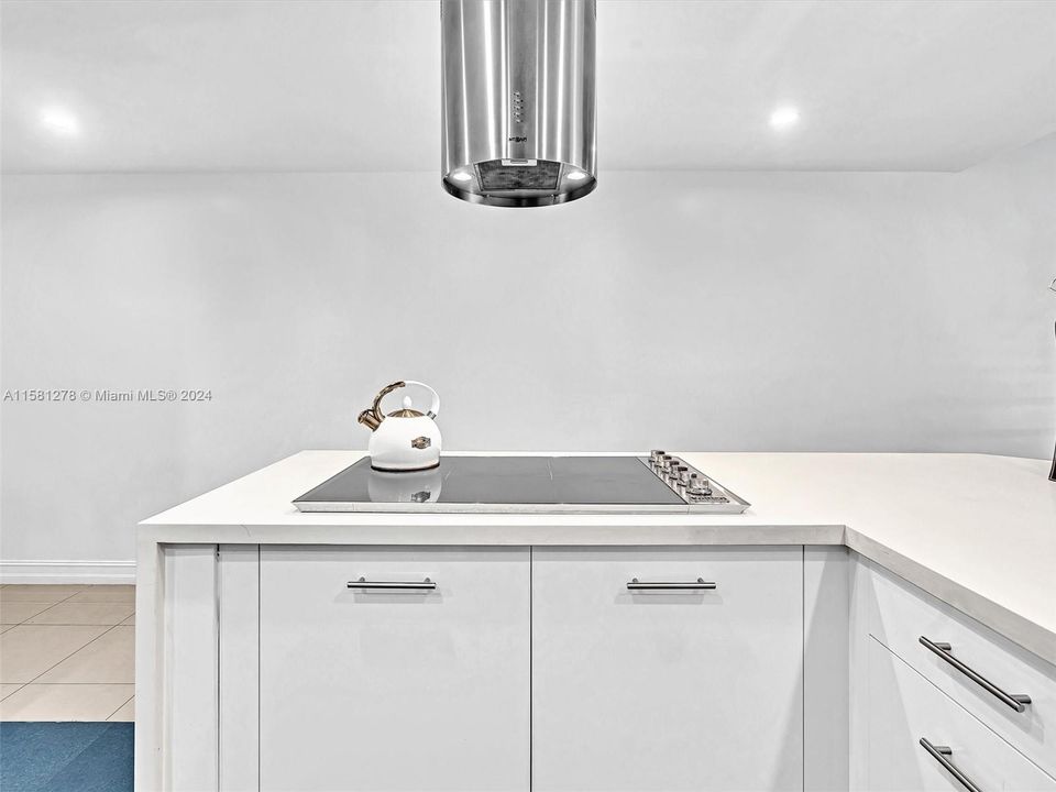 Unique rounded range hood, which complements the kitchen design