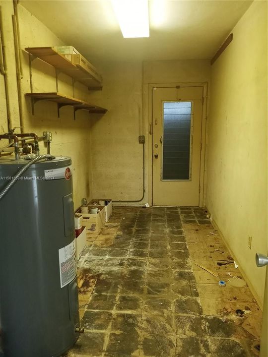 Utility room that leads to enclosed carport.