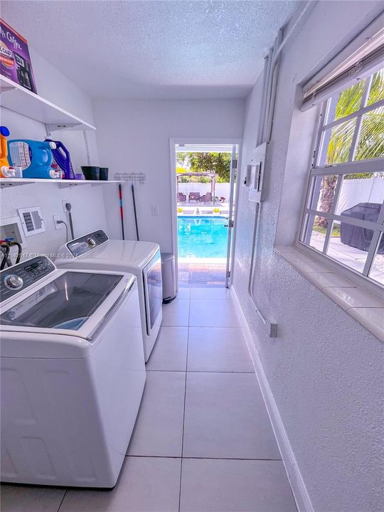 Spacious Laundry Room with Access to Pool and Backyard