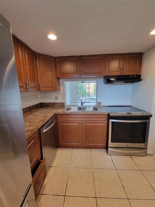 Renovated kitchen with stainless steel appliances.