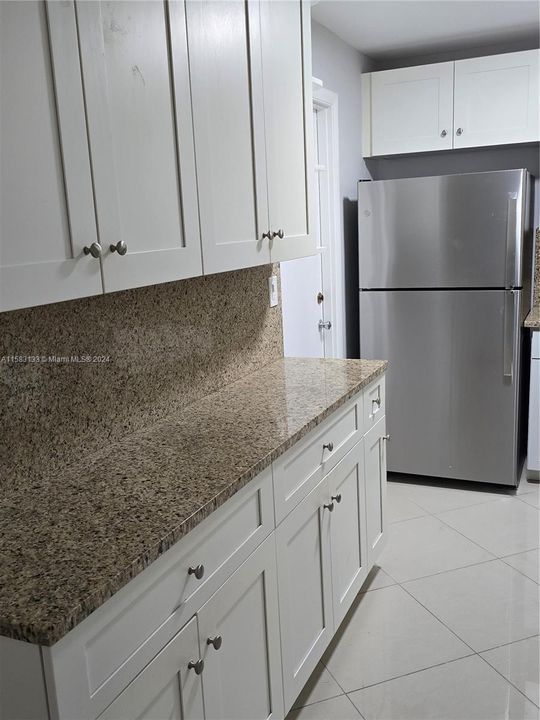 1 view of kitchen - custom while wood cabinetry and granite counter + new stainless steel fridge