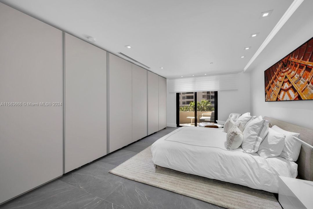 Custom designed sliding closet system with incredible storage & use of space.