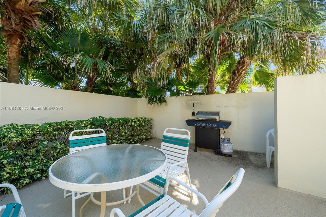 oceanfront heated pool, shuffleboard,  outdoor shower in fenced in area. bocce ball court is on the outside. Paths to beach and picnic tables. Also in this photo on the left is building A