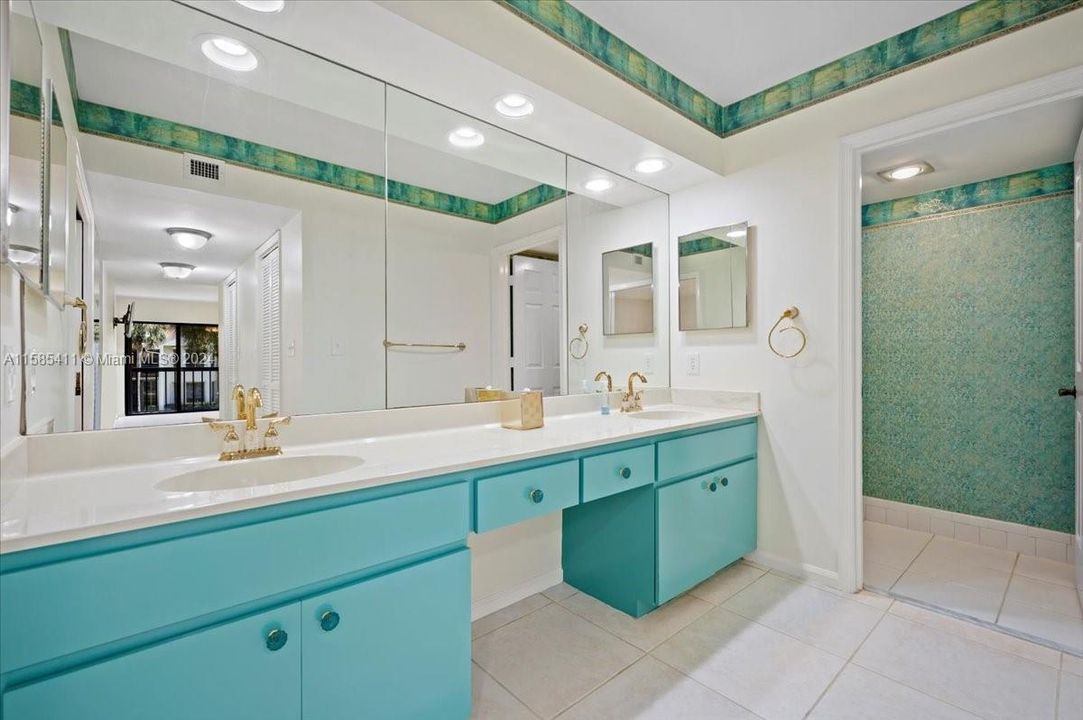 Double sinks with a pop of freshly painted color. Private toilet area in the Master Bathroom