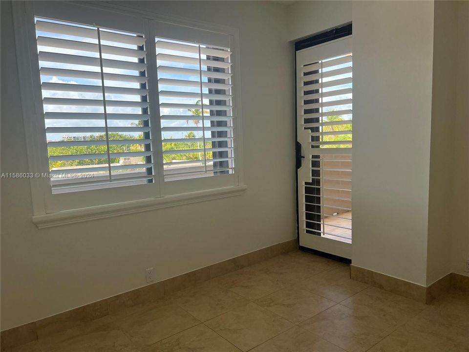 Large master bedroom with Bahamian shutters