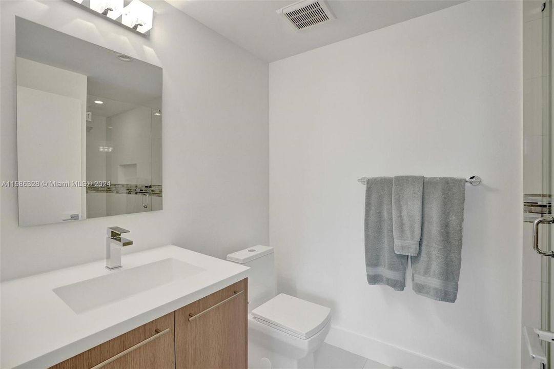 Entry Level bedroom's full size bathroom with huge shower.