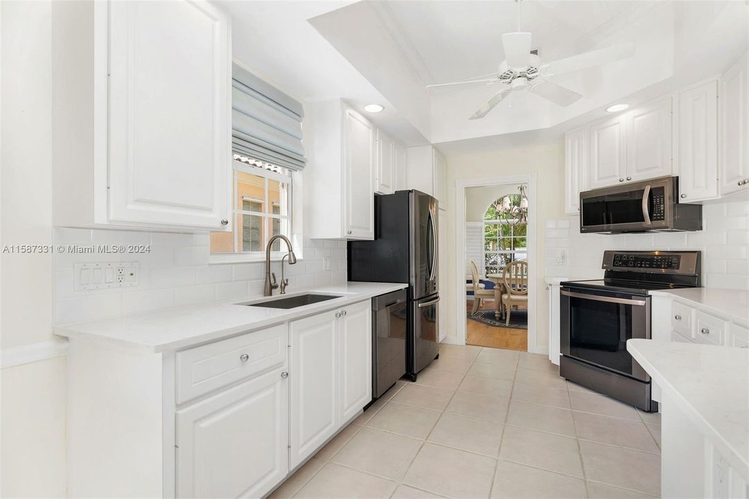 Features quartz countertops, pantry, water filtration system and SS appliances.