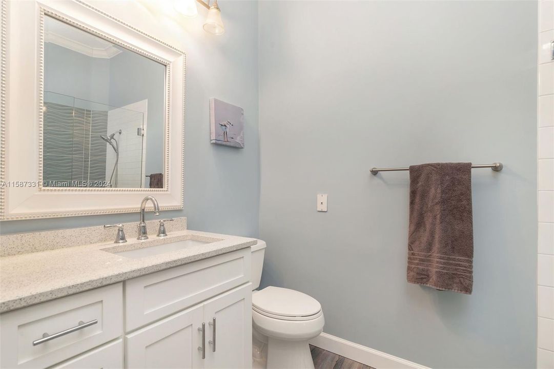 Primary his bath, remodeled with quartz top, step in shower.