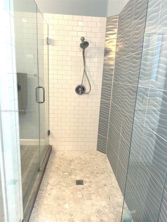 Primary Suite remodeled step down shower.