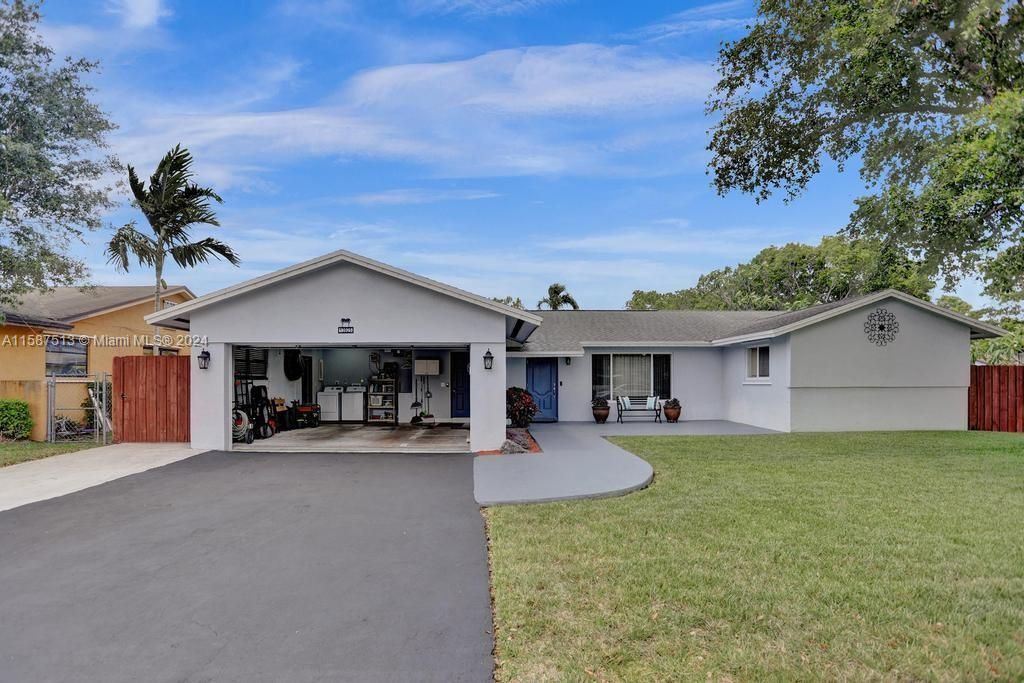 two car garage boasts room for 2 cars, laundry AND lots of cabinets and storage space