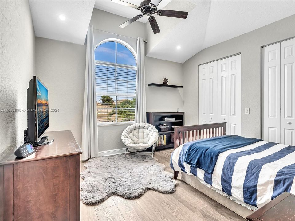 4th bedroom with stunning high ceilings and arched windows