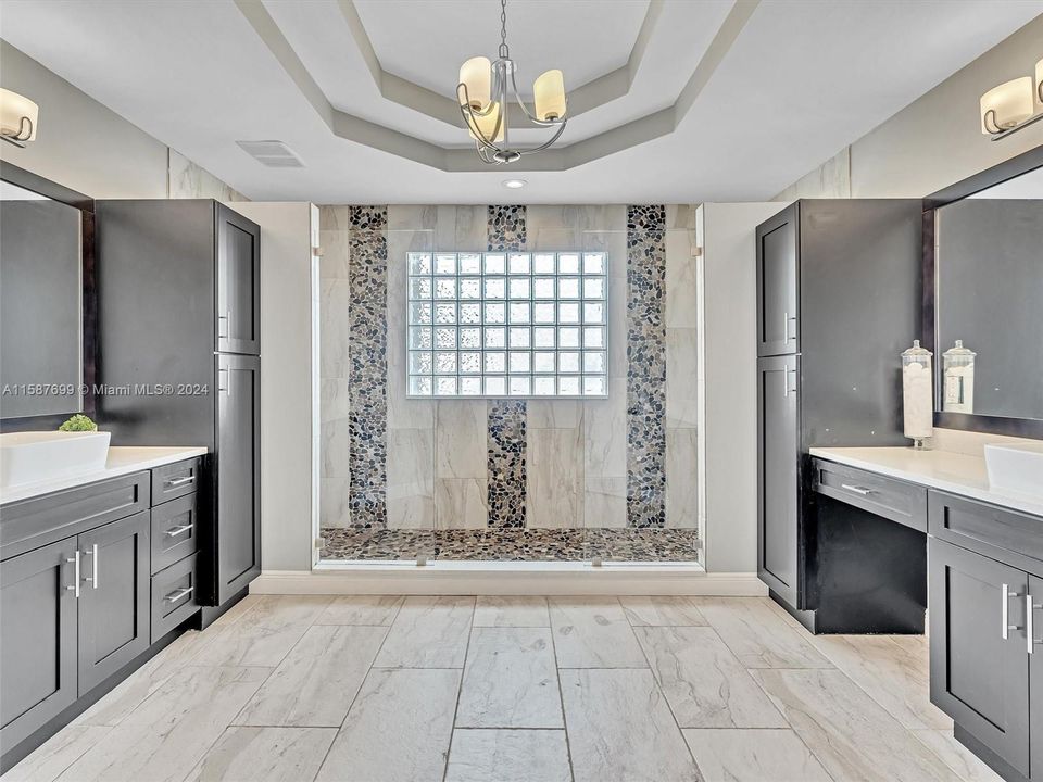 Luxurious primary bathroom with his/her sinks AND his/hers showers!