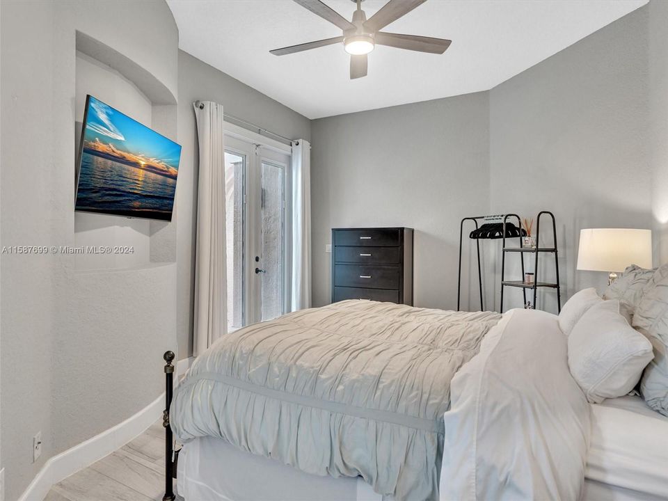 5th bedroom with impact doors leading out to courtyard