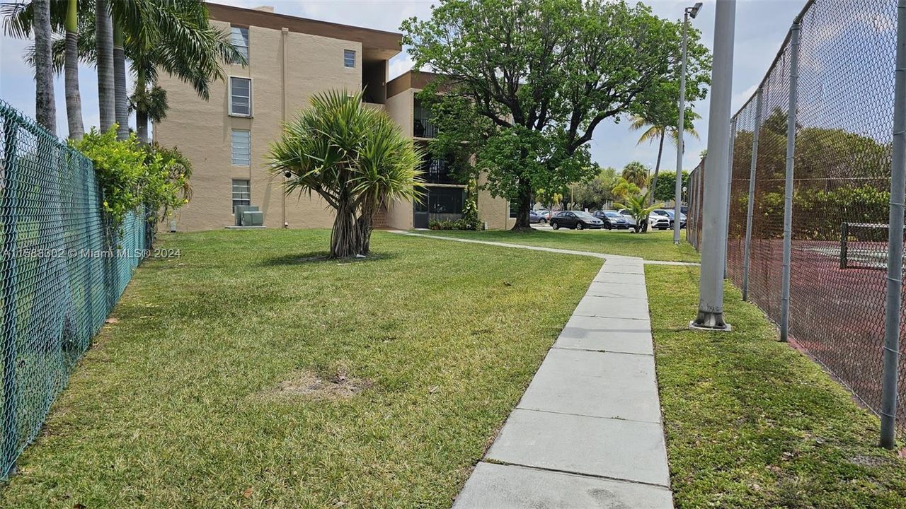 Green area and tennis court on the left