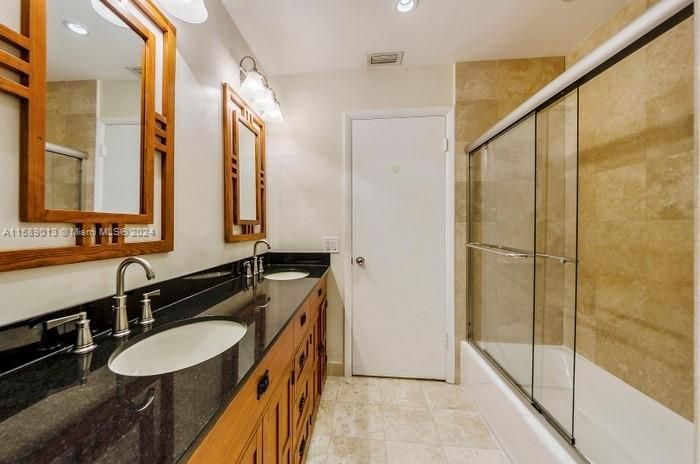 The Children's Bathroom with double sinks, tub/shower and the bath opens to the Pool-Patio so that no one has to walk thru the house to use the bathroom!