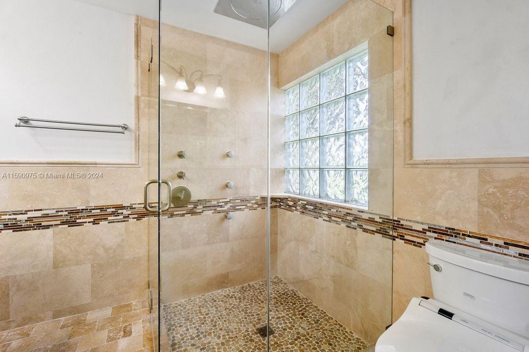 Just look at this shower- your own walk in spa!  Frameless shower door, stone shower floor with plenty of jets and Rain head shower head.