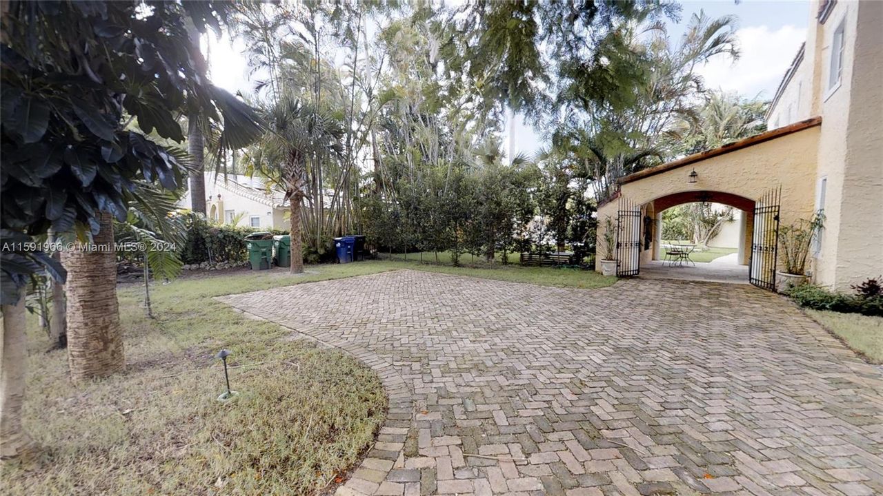 Entrance to parking with gorgeous carport .