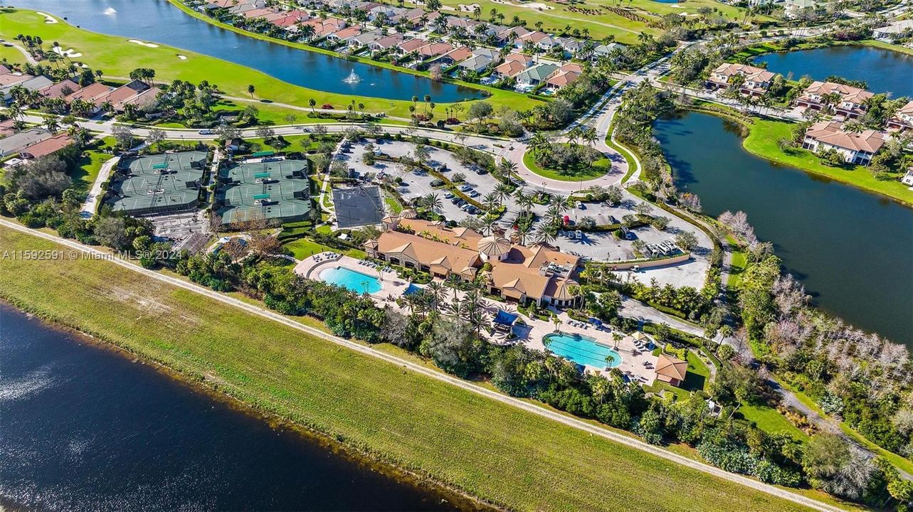 Ariel view of fitness center, two pools pickleball and tennis courts and play area