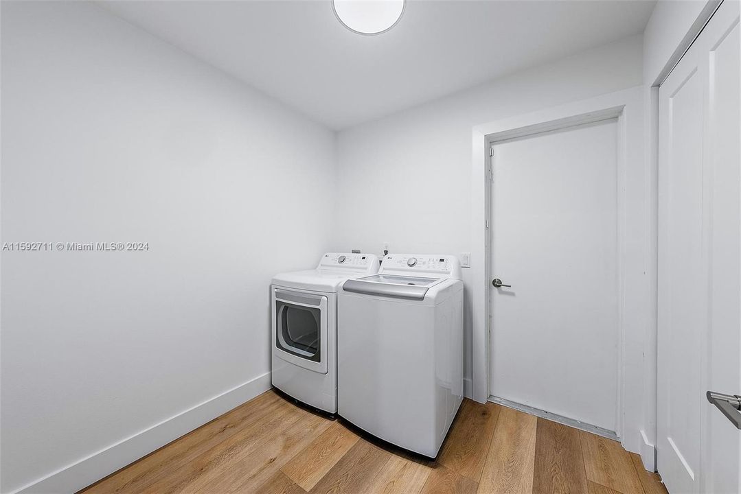 Laundry room with extra storage closet. Laundry tub located on other side of door in the garage.