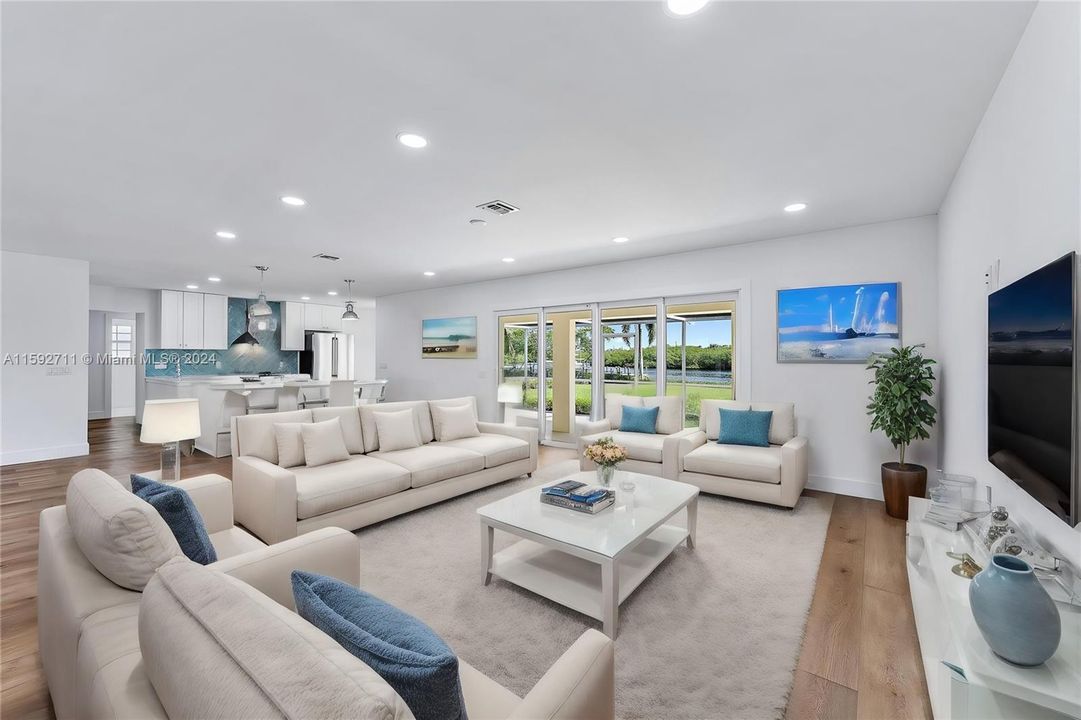 Open floor plan Living room and Kitchen view. Impact sliding doors to patio/lanai and waterviews.