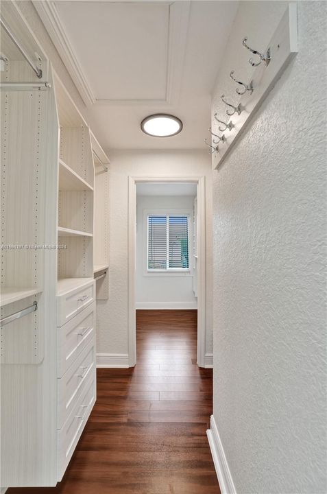 Primary walk in closet. His and her's side.